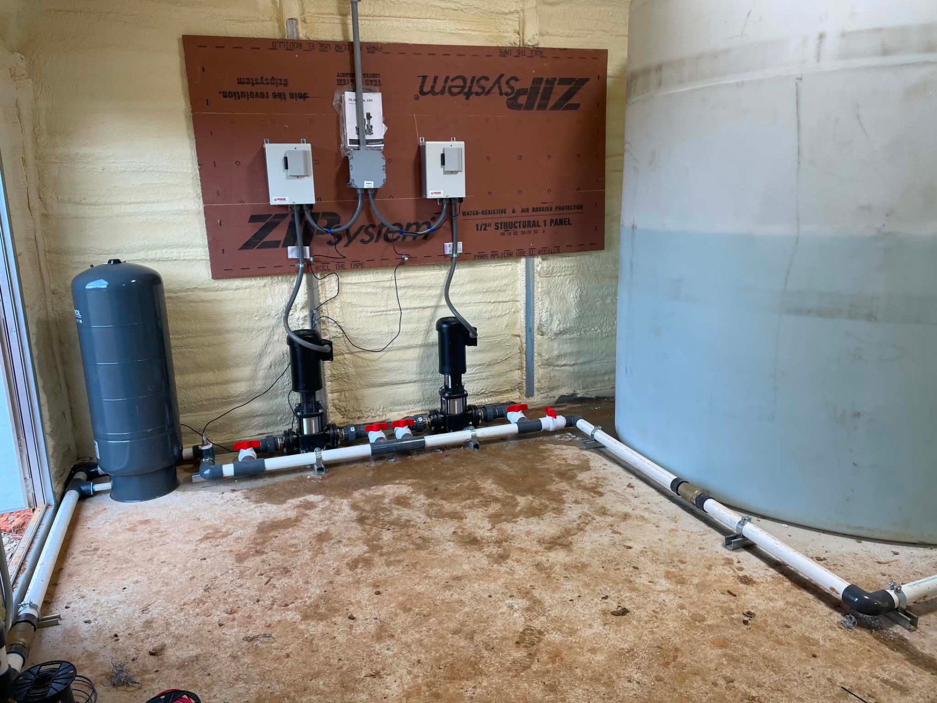 Booster pump room with vertical pumps, valves and control panels operated by EMS