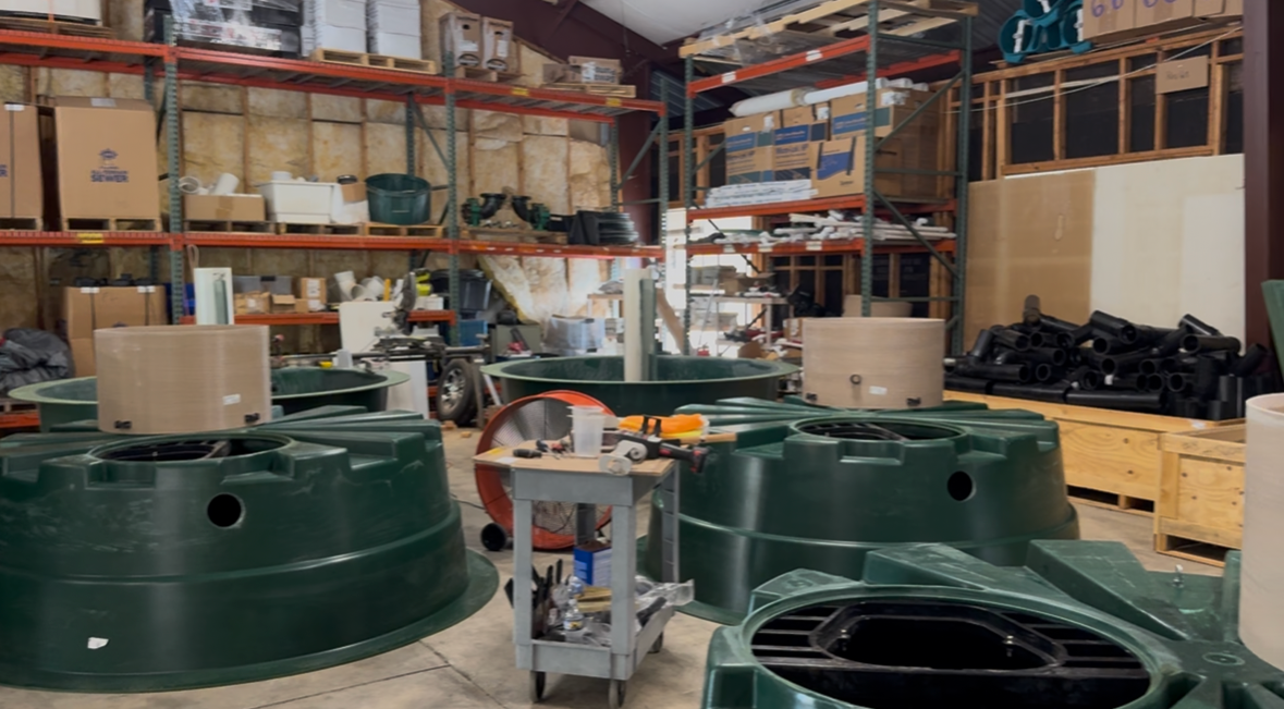 EMS warehouse stocked with Orenco tanks, risers, pumps and control components on the shelves